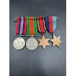 Militaria: A WWII Medal Bar to include War Medal, Defence Medal, The Burma Star and 1939-45 Star.