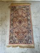A pink ground pray mat or rug with floral border (126cm x 58cm)