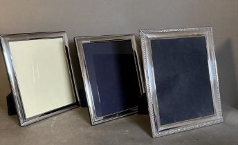A selection of three silver picture frames, largest is 32 cm x 27.5 cm