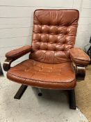A Scandinavian mid century reclining chair in brown leather