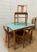 A Mid Century Formica topped table and four chairs (H74cm W100cm D71cm)