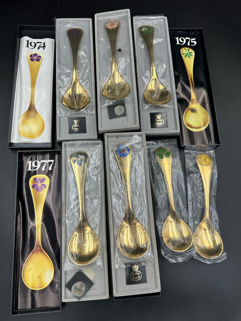 Georg Jensen, seven modern Danish silver-gilt and enamel year spoons,1972, 1974-79 the terminals - Image 2 of 3