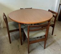 A round Mid Century table with four chairs and an extra centre leaf (H75cm Dia120cm)