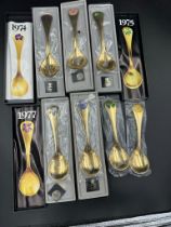 Georg Jensen, seven modern Danish silver-gilt and enamel year spoons,1972, 1974-79 the terminals