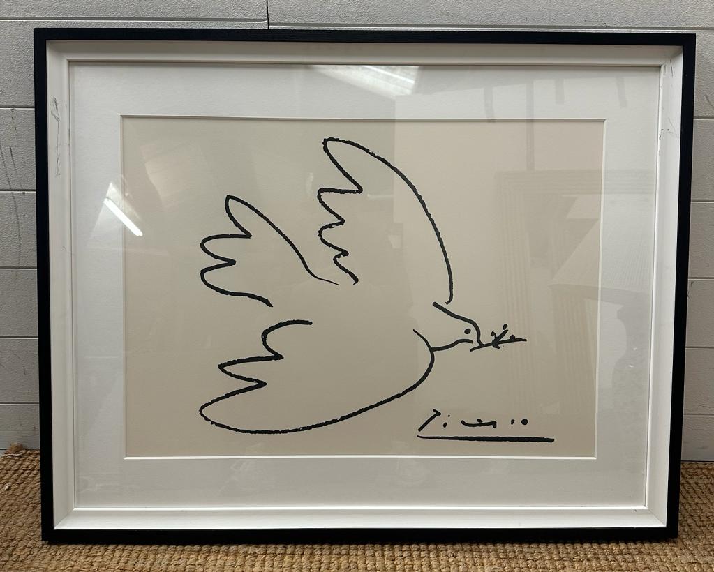 A framed print of Picasso's "Dove of Peace" 50cm x 68cm