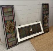A selection of three leaded stained glass panels, one featuring the number 16. 103x30