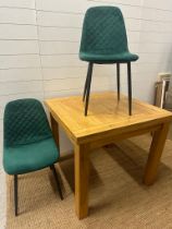 An oak kitchen table and two contemporary green dining chairs (H78cm SQ90cm)
