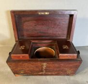 A mahogany tea caddy with mother of pearl inlay and turned handles