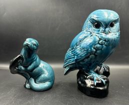 Two Poole pottery blue dolphin glaze animals. An owl on a black plinth and an otter