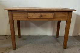 A pine kitchen table with single drawer to centre (H78cm D66cm W119cm)