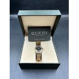 A GUCCI ladies watch in box with papers