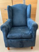 A small blue wing back chair