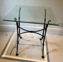 A glass top side table on wrought iron legs (H61cm SQ56cm)