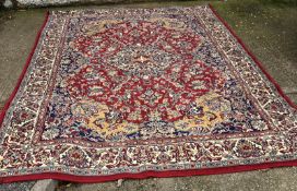 A large red ground rug with geometric pattern 296cm x 396cm
