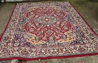 A large red ground rug with geometric pattern 296cm x 396cm