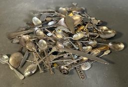 A selection of white metal and silver plated items to include tea spoons, dessert spoons and a