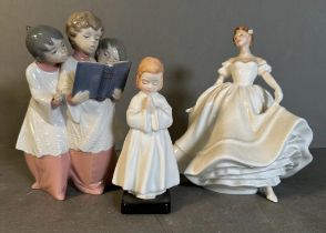 A Lladro figurine of Choristers and two Royal Doulton Nancy and Bedtime