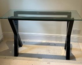 A cross frame console table with glass top