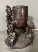 A Heavy East African carved pot on stand. 32cm H