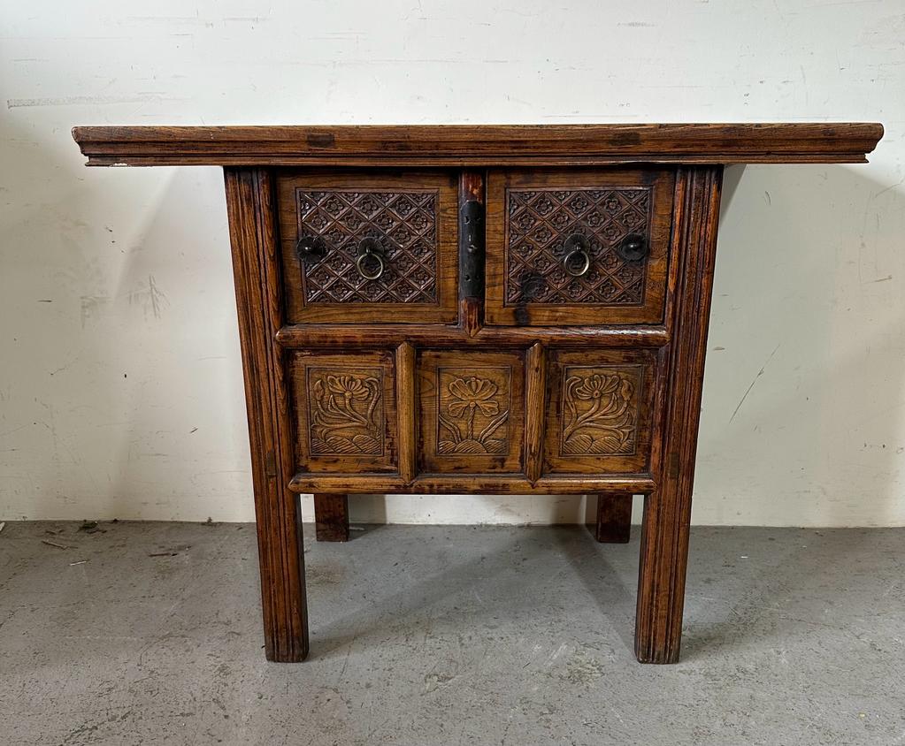 A vintage Burmese two drawer wine table with carved floral detail (H85cm W108cm D55cm)