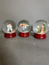 A selection of two Coalport "The Snowman" snow globes and one glitter globe, boxed