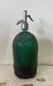 A vintage green glass soda siphon