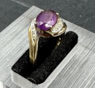 A 9ct gold ring with amethyst style stone.