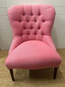 A pink upholstered button back salon chair on turned mahogany legs