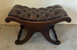 A Regency style brown leather saddle seat (H40cm W68cm D44cm)