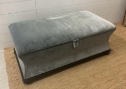 A contemporary ottoman upholstered in grey velour (H43cm D55cm W106cm)