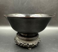 A 19th Century Chinese black glazed bowl on stand