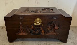 An oriental carved lockable box (H48cm W94cm D46cm)