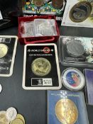 A selection of collectable coins, packs and loose coins