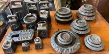 A sizeable collection of cast iron scale weights, various makers and weights.