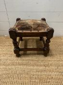 An oak upholstered foot stool on barley twist supports (H30cm)