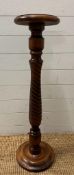 A mahogany plant stand on turned central column (H93cm Dia26cm)