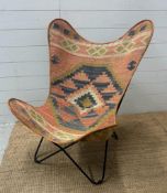 A Buffalo multi coloured butterfly chair.