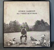 A vinyl copy of George Harrison "All Things Must Pass" (Booklet missing)