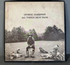 A vinyl copy of George Harrison "All Things Must Pass" (Booklet missing)