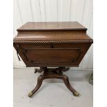 A Regency style Cellarette. The Mahogany caddy opening to compartments and panelled front.
