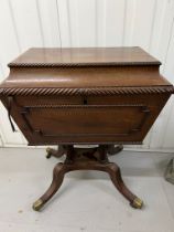 A Regency style Cellarette. The Mahogany caddy opening to compartments and panelled front.