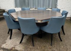 A contemporary octagonal dining table and ten grey/blue upholstered chairs Diameter194cm