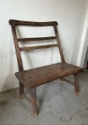 A rustic single seater oak bench (H98cm W56cm D82cm)