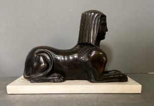 A Bronze cast of a Sphynx with typical head-dress on a marble base (29cm x 12cm base)
