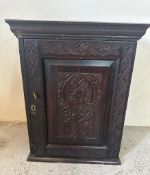 A small hardwood carved wall cupboard with two shelves and three drawers (H70cm W55cm D25cm)