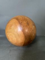 A large contemporary sculptural wooden ball