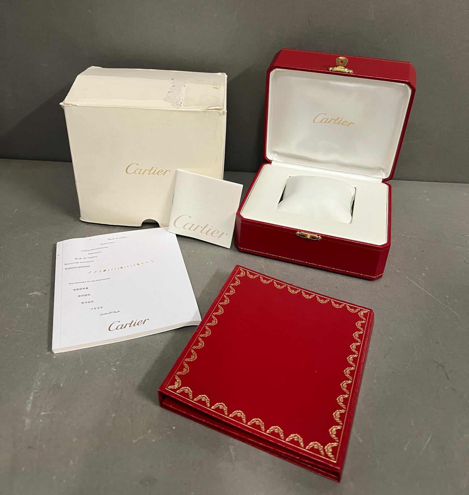 A Cartier watch box with booklet, cd and outer box