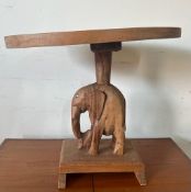 A small tribal art side table with central carved elephant (H34cm W40cm D26cm)