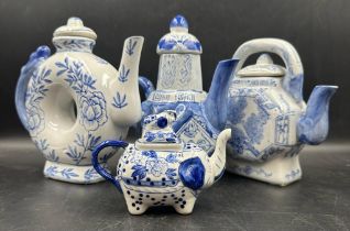 A selection of four Chinese blue and white tea pots to include a doughnut shaped and a miniature