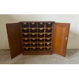 An oak postmaster pigeon hole sorting cupboard made up of twenty four sorting departments (H66cm